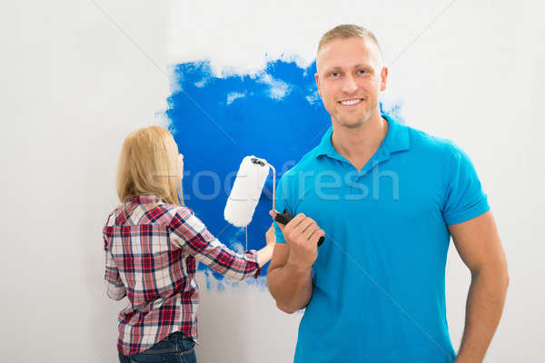 Young Man Holding Paint Roller Stock photo © AndreyPopov