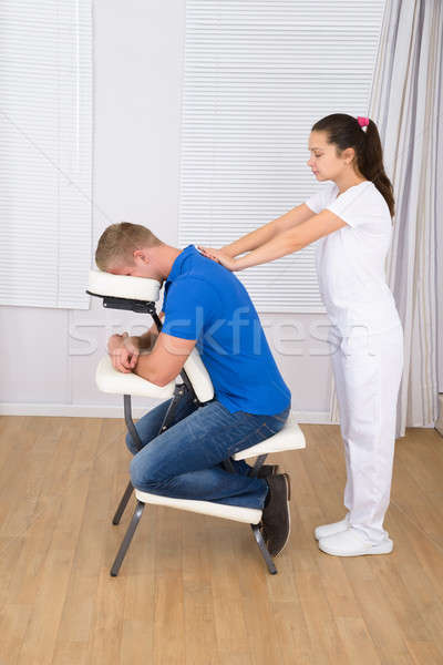 Masseuse Massaging Man's Shoulder Stock photo © AndreyPopov
