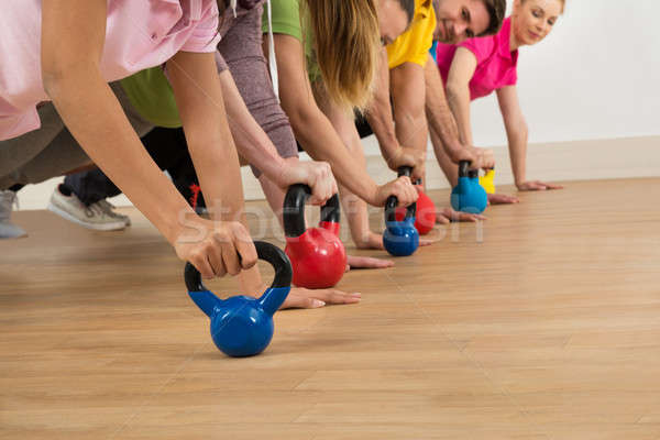 People Holding Colorful Kettle Bell Stock photo © AndreyPopov