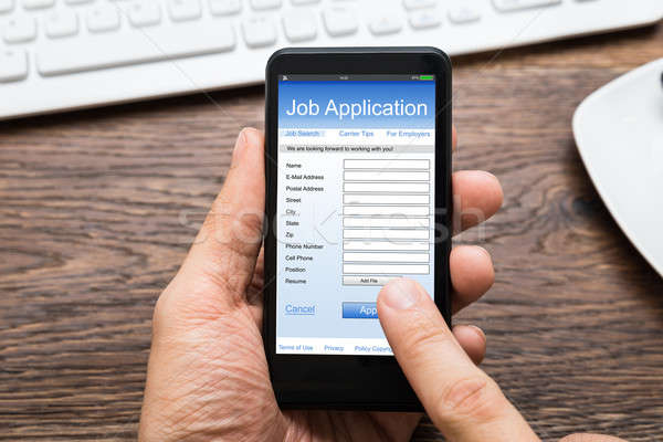 Person Hands Filling Job Application On Mobile Phone Stock photo © AndreyPopov