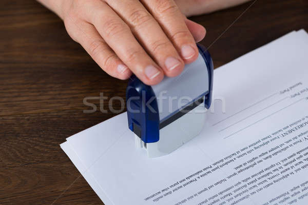 Person Hands Stamping Document Stock photo © AndreyPopov
