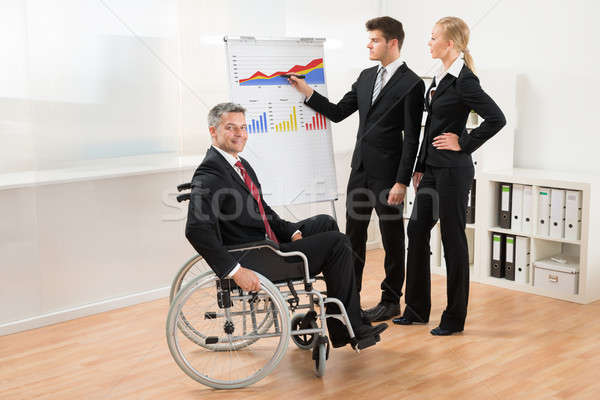 Businessman Explaining Graph To His Team Stock photo © AndreyPopov
