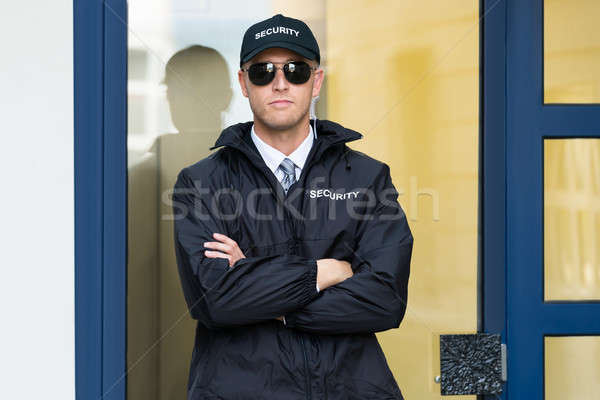 Male Security Guard Standing At The Entrance Stock photo © AndreyPopov