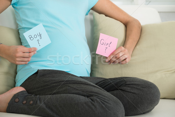 Pregnant Woman Holding Boy And Girl Notes Stock photo © AndreyPopov
