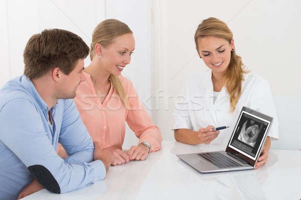 Doctor Showing Ultrasound Scan Of Baby To Couple Stock photo © AndreyPopov