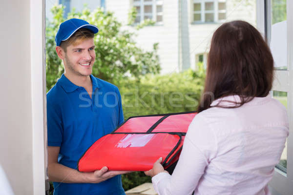 Man Delivering Pizza To Young Woman Stock photo © AndreyPopov