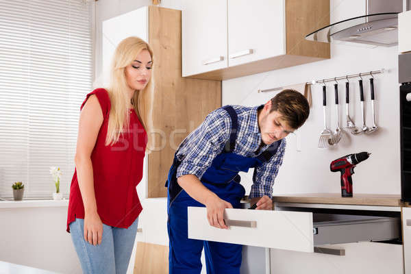 Male Worker Repairing Drawer In Kitchen Stock photo © AndreyPopov