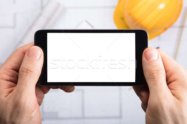 An Engineer Holding Cell Phone Stock photo © AndreyPopov