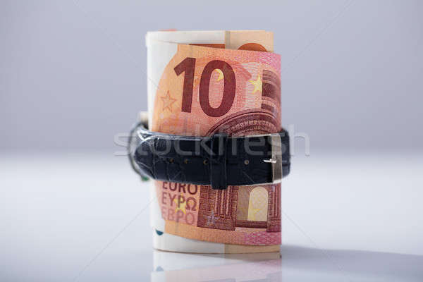 Rolled Up Ten Euro Banknotes Tied With Belt Stock photo © AndreyPopov