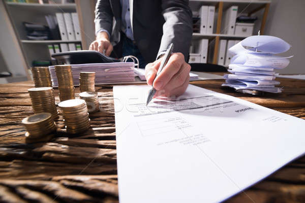 Close-up Of A Businessperson's Hand Signing Document Stock photo © AndreyPopov