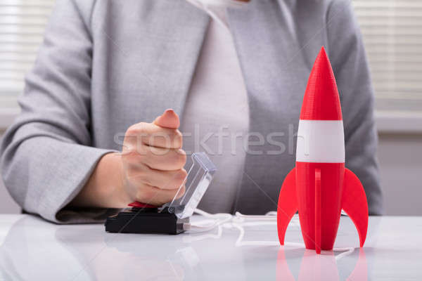 Businesswoman's Hand Launching Rocket Stock photo © AndreyPopov