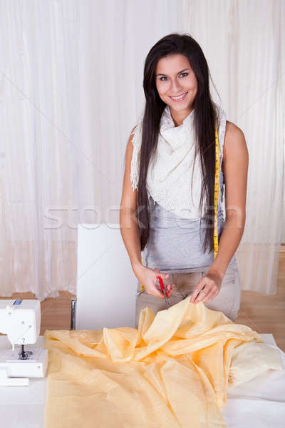 Beautiful woman cutting fabric Stock photo © AndreyPopov