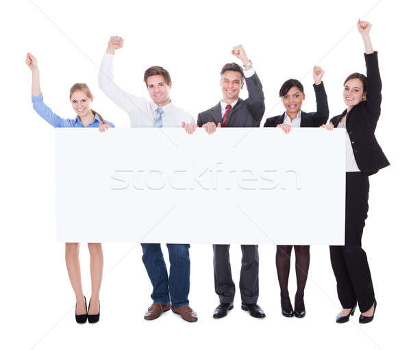 Businesspeople Raising Hand With Board Stock photo © AndreyPopov