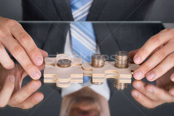 Kezek kapcsolódik puzzle érmék asztal üzlet Stock fotó © AndreyPopov