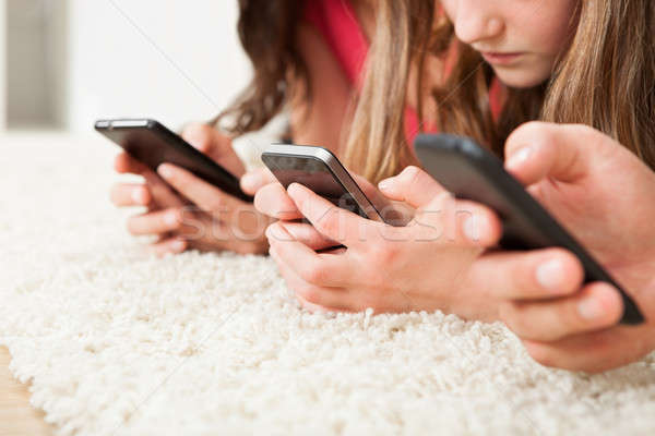 Family Using Smart Phones On Rug Stock photo © AndreyPopov