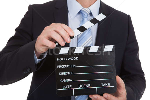 Businessman Holding Clapboard Stock photo © AndreyPopov