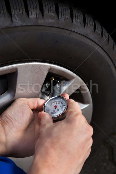 Mechanic Checking Tire Pressure Using Gauge Stock photo © AndreyPopov