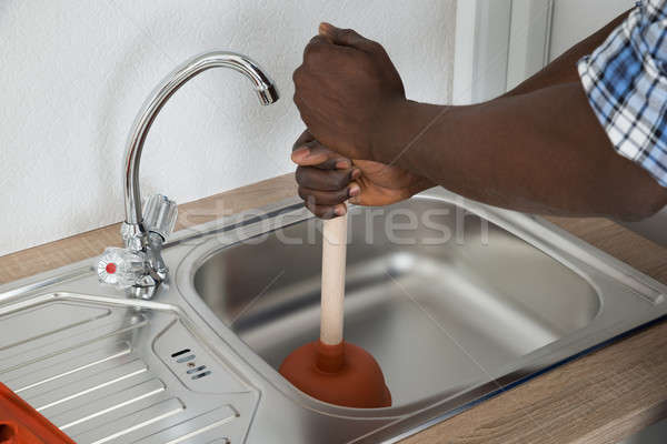 Plumber Cleaning Sink With Plunger Stock photo © AndreyPopov