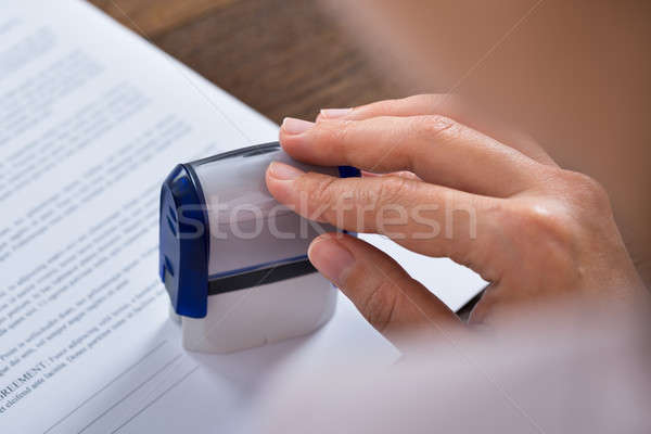 Person Hands With Stamper And Document Stock photo © AndreyPopov