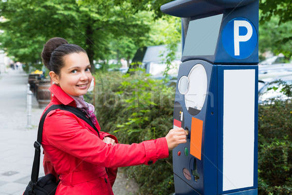 Woman Inserting Coin In Parking Meter Stock photo © AndreyPopov