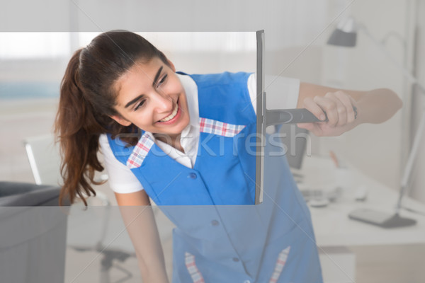 Stock photo: Smiling Female Worker Cleaning Glass Window With Squeegee