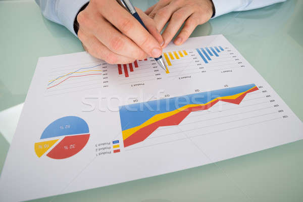 Stock photo: Businessman Analyzing Graphs On Paper