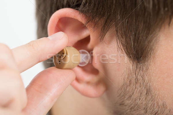 Człowiek aparat słuchowy ucha młody człowiek Zdjęcia stock © AndreyPopov