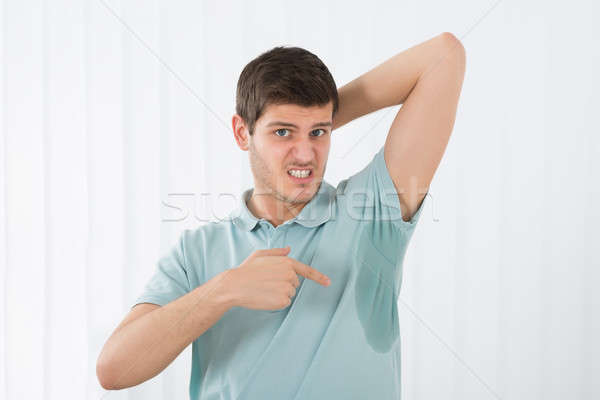 Stock photo: Man Pointing To A Sweat Armpit