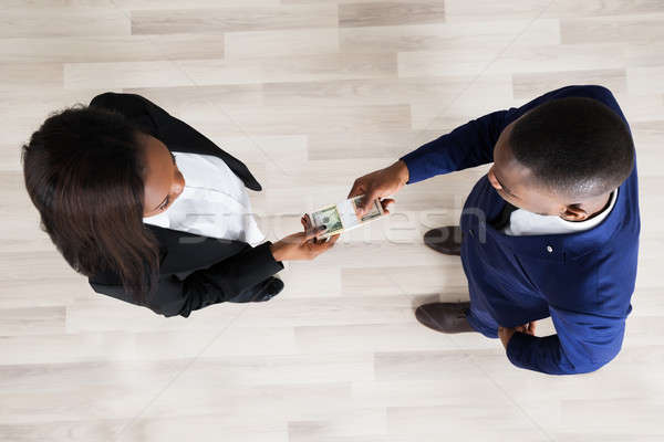 Business Man And Woman Exchanging Money Stock photo © AndreyPopov