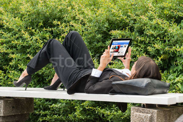 Businesswoman Reading News On Digital Tablet Stock photo © AndreyPopov