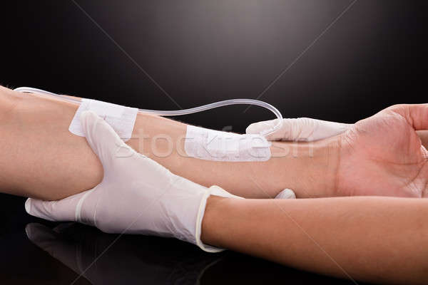 Doctor Holding Patient's Hand With Iv Drip Stock photo © AndreyPopov