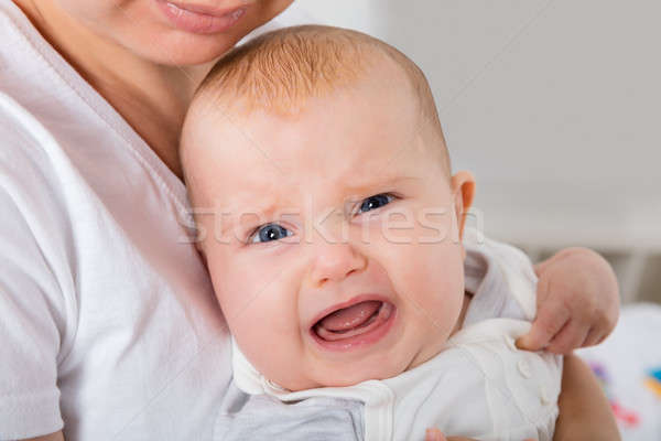 Crying Child On Mother's Arm Stock photo © AndreyPopov