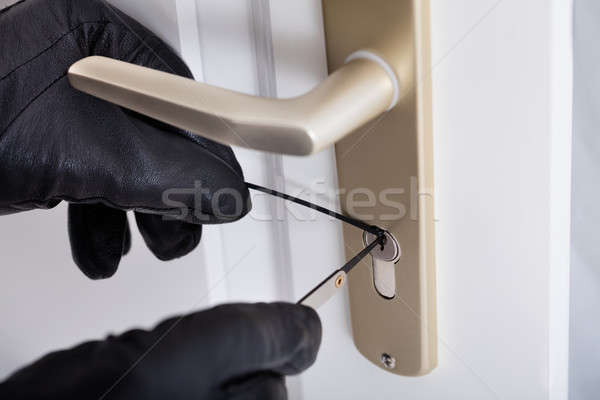 Burglar With Gloves Picking Lock Stock photo © AndreyPopov
