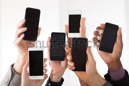 Businesspeople Showing Smart Phone Stock photo © AndreyPopov