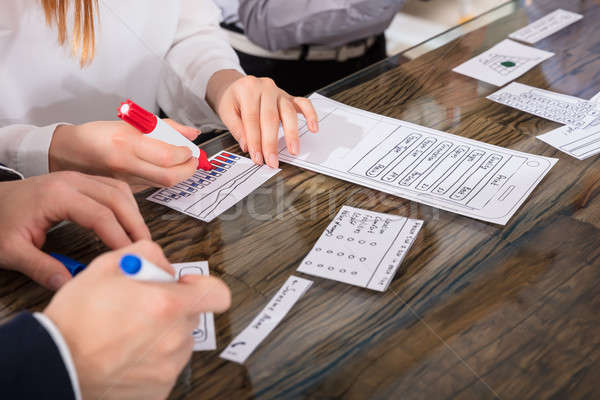 деловые люди мобильных применение развивающийся бумаги столе Сток-фото © AndreyPopov