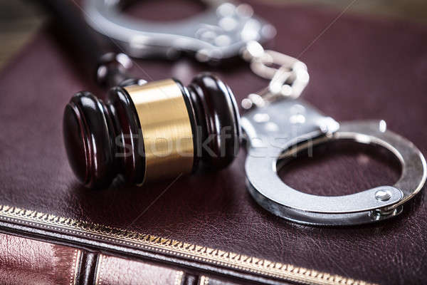 Handcuffs And Gavel On Law Book Stock photo © AndreyPopov