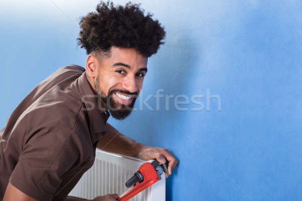 Plumber Fixing Radiator With Wrench Stock photo © AndreyPopov