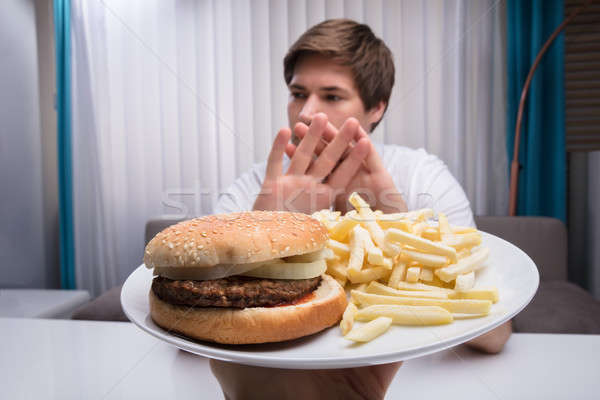 Mann ungesunde Lebensmittel Frau Essen home Fleisch Stock foto © AndreyPopov