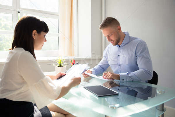 Two Businesspeople Looking At Document Stock photo © AndreyPopov