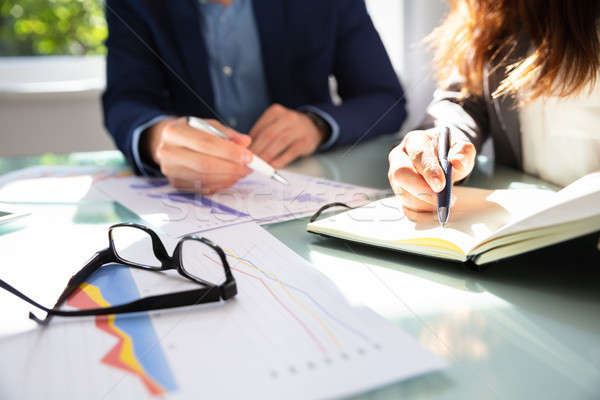 Stock photo: Businesswoman Writing Note In Diary