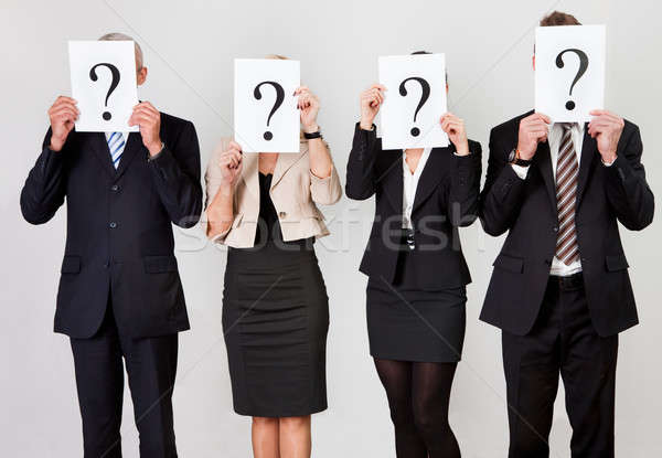 Gruppe Geschäftsleute versteckt Fragezeichen Büro Hintergrund Stock foto © AndreyPopov