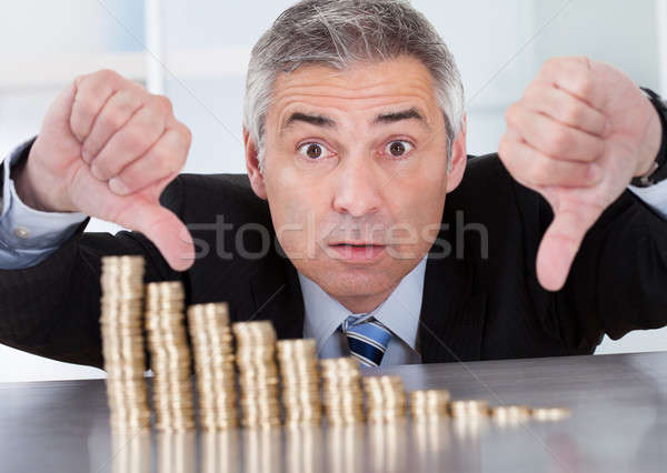 Stock photo: Shocked Businessman With Stack Of Coins