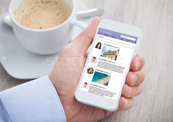 Businessman Surfing Social Networking Site On Mobilephone Stock photo © AndreyPopov