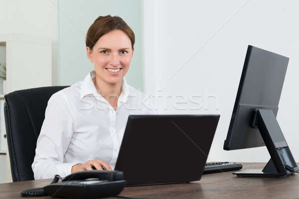 Businesswoman Working On Laptop And Desktop Computer Stock photo © AndreyPopov