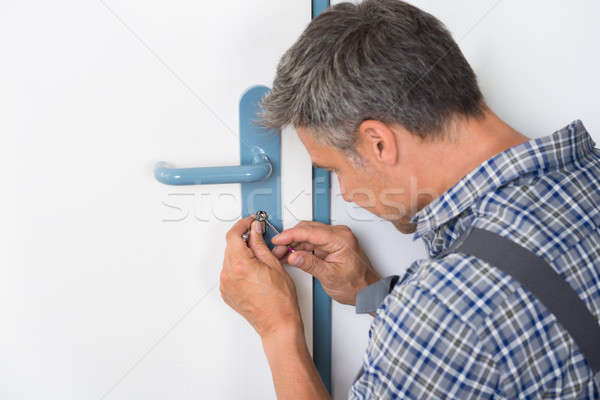 Lockpicker Fixing Door Handle At Home Stock photo © AndreyPopov