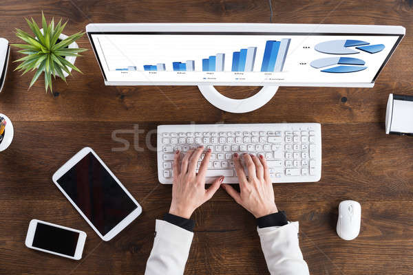 Businessperson Analyzing Graph On Computer Stock photo © AndreyPopov