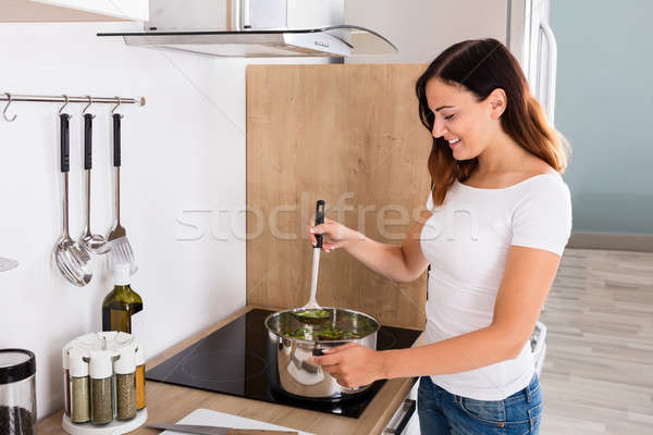 Woman Preparing Meal In Kitchen Stock photo © AndreyPopov