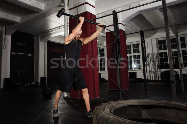 Fitness Man Hitting A Tractor Tire With Hammer Stock photo © AndreyPopov
