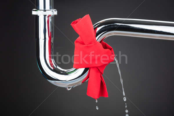 Red Cloth Tied On Leakage Pipe Stock photo © AndreyPopov