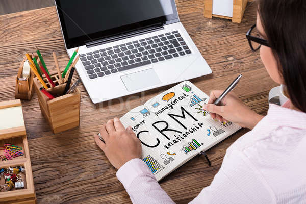 Mujer de negocios dibujo crm plan cuaderno primer plano Foto stock © AndreyPopov
